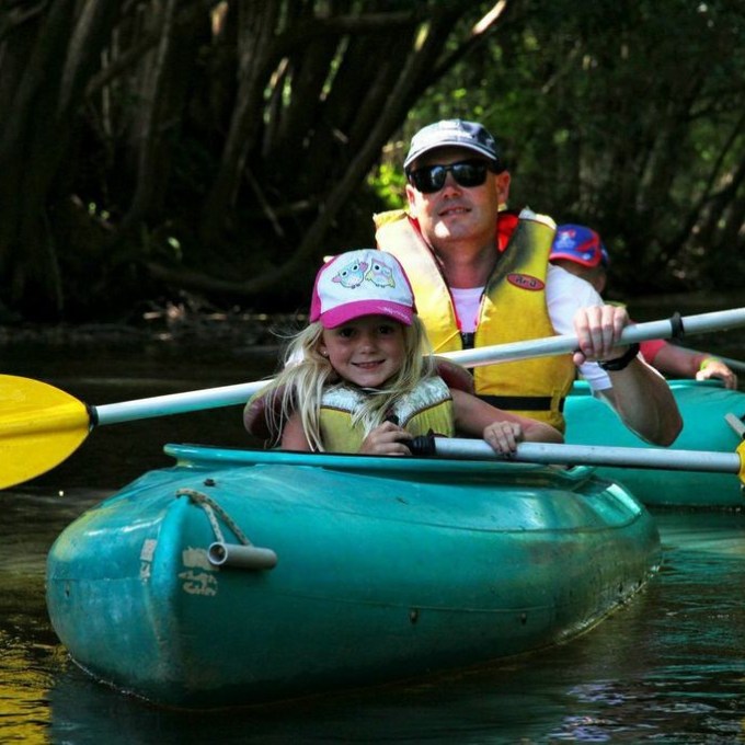 a group of people riding on the back of a boat