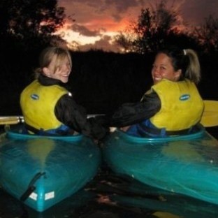 a couple of people that are standing in the water