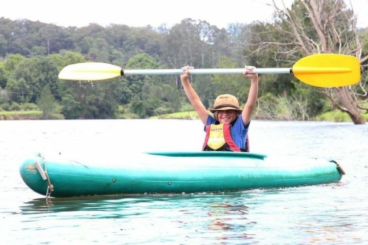 a man riding a surfboard on top of a body of water