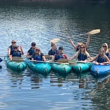 a group of people on a boat in the water