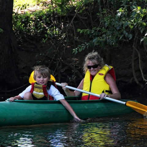a person riding on the back of a boat in the water