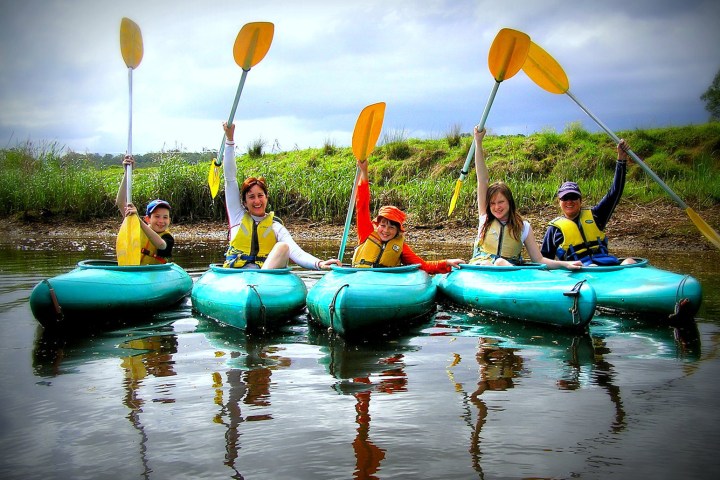 a group of people riding on the back of a boat