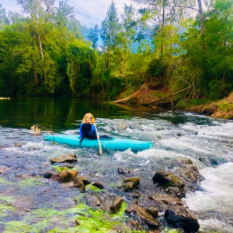 a raft next to a body of water surrounded by trees