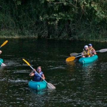 a group of people on a raft in a body of water