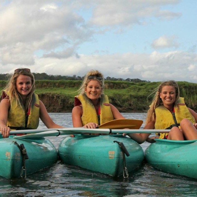 a group of people riding on the back of a boat